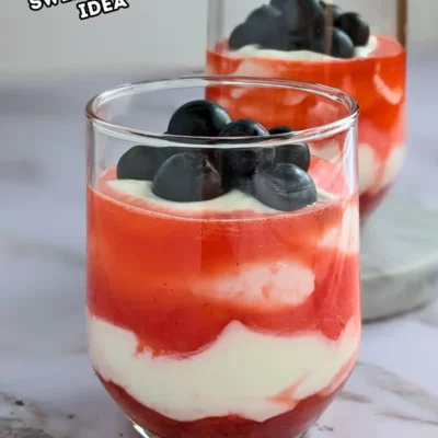Greek Yogurt Strawberry Fool - whipped Greek yogurt, whipped cream, and strawberry dessert made with alternating layers of stewed strawberries and yogurt-whipped cream mix, topped with blueberries for an extra burst of color.