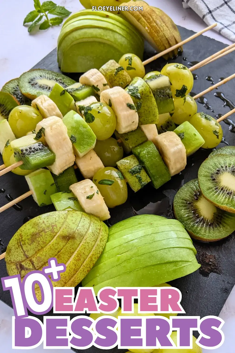 Green Fruit Tray - colorful green-themed fruit tray with green fruit kabobs featuring fruits like kiwi, green grapes, green apple, green pear, and bananas that are drizzled with a fresh mint, lime juice, and maple sryup sauce, plus slices of green apple, green pear, kiwis, and little piles of green grapes.