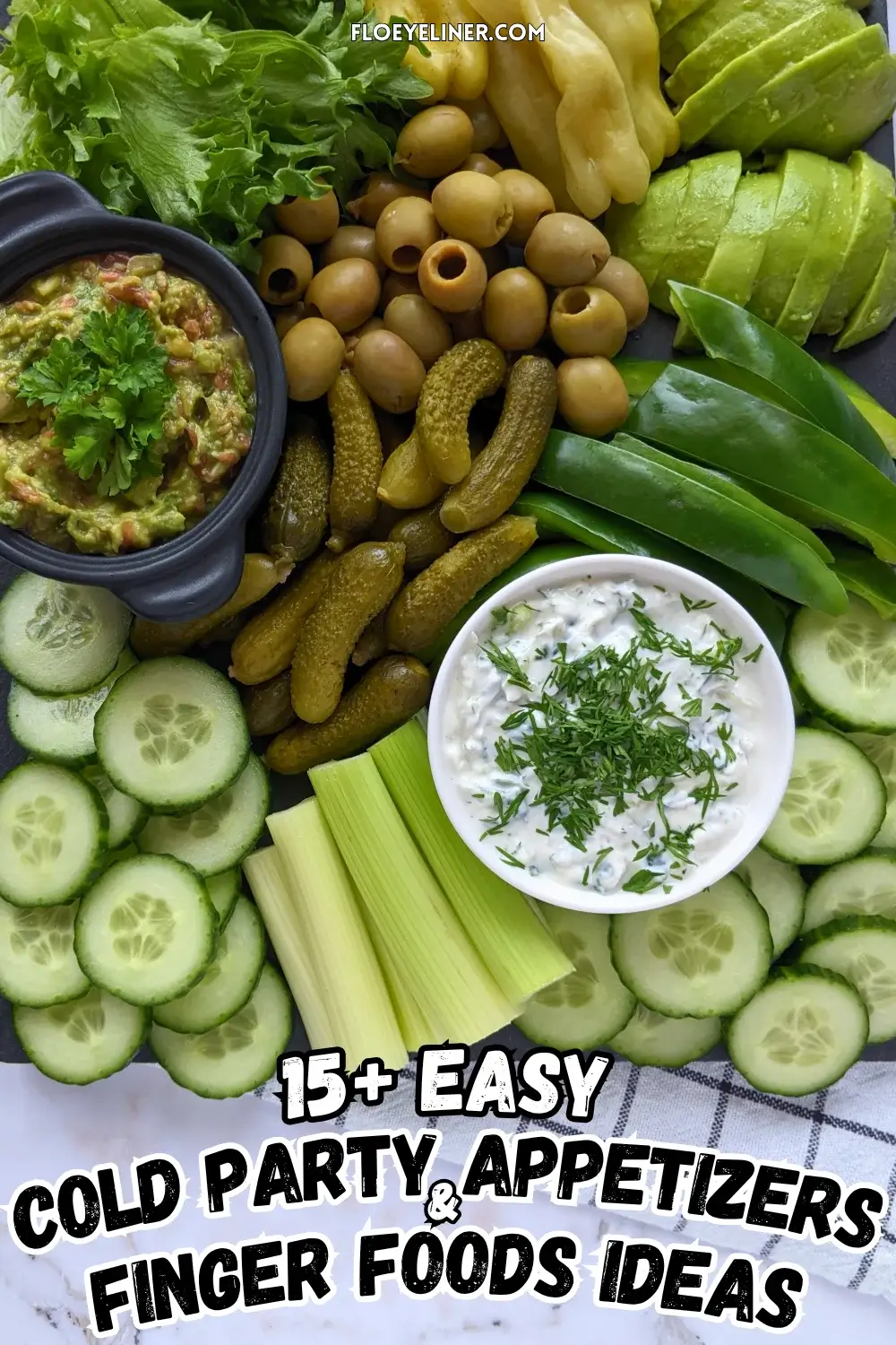 Green Veggie Tray - Green themed vegetable board with homemade guacamole and tzatziki sauce; fresh vegetables like cucumber, green bell peppers, celery, frillice lettuce, and avocado; and pickled foods like mini pickles, jalapenos, and olives in brine.