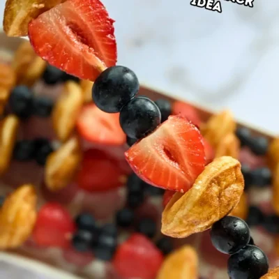 Mini Pancake Skewers With Fresh Berries - dessert skewers on toothpicks made with alternating layers of mini pancakes and fresh strawberries and blueberries.