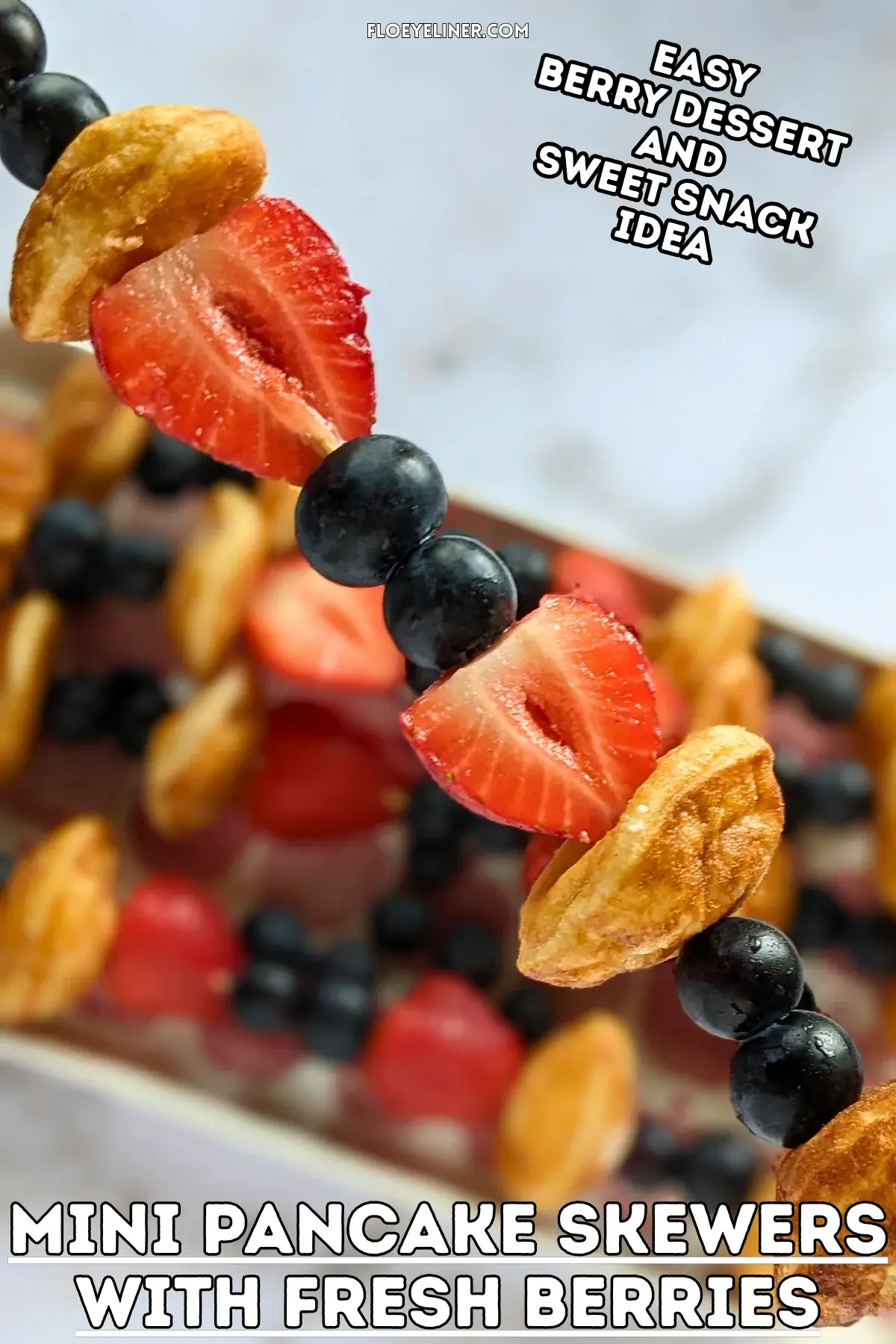 Mini Pancake Skewers With Fresh Berries - dessert skewers on toothpicks made with alternating layers of mini pancakes and fresh strawberries and blueberries.