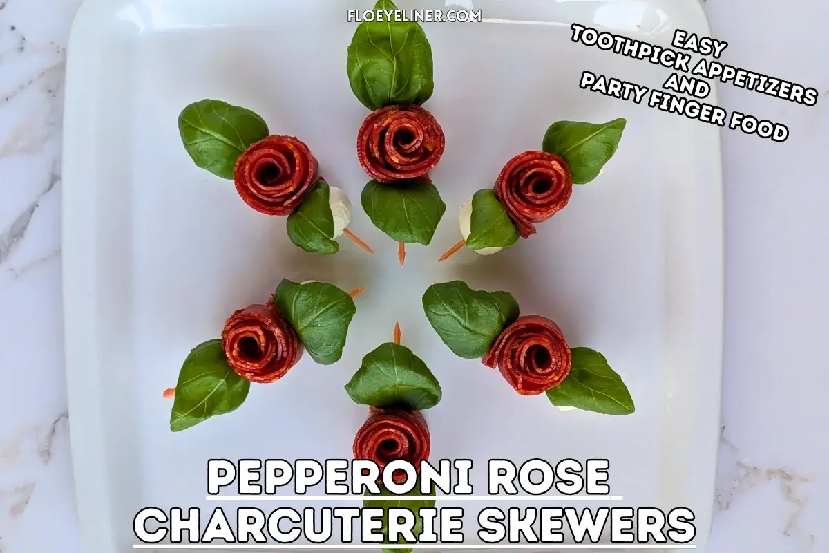 Pepperoni Rose Charcuterie Skewers - party appetizers and finger food on toothpicks made with slices of pepperoni rolled up into roses, fresh basil leaves for rose leaves, and mini mozzarella balls.