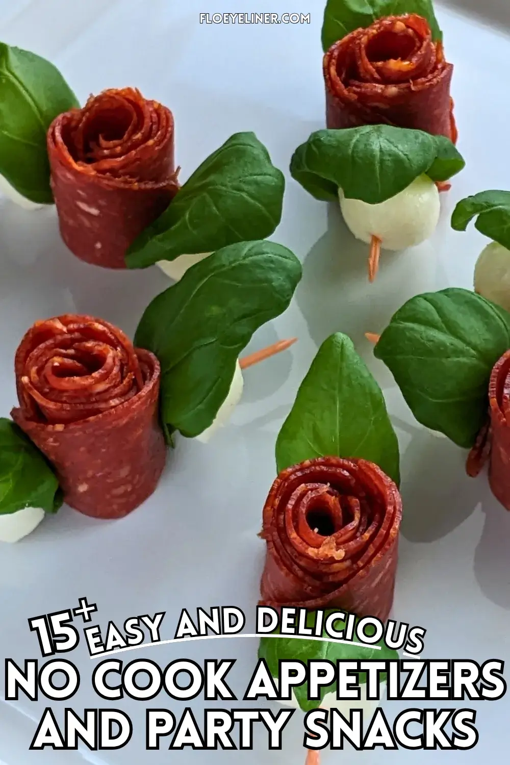 Pepperoni Rose Charcuterie Skewers - party appetizers and finger food on toothpicks made with slices of pepperoni rolled up into roses, fresh basil leaves for rose leaves, and mini mozzarella balls.