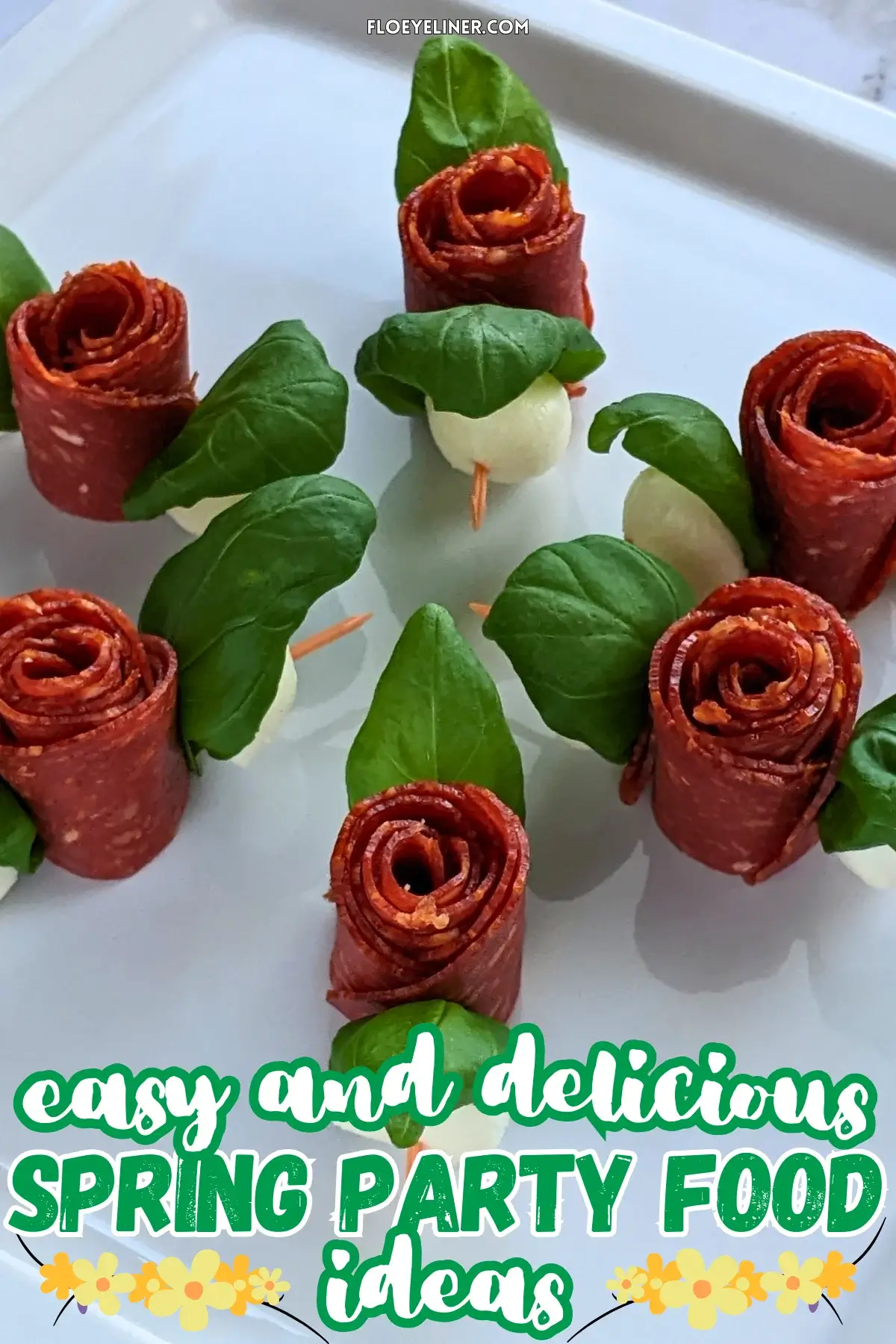 Pepperoni Rose Charcuterie Skewers - party appetizers and finger food on toothpicks made with slices of pepperoni rolled up into roses, fresh basil leaves for rose leaves, and mini mozzarella balls.