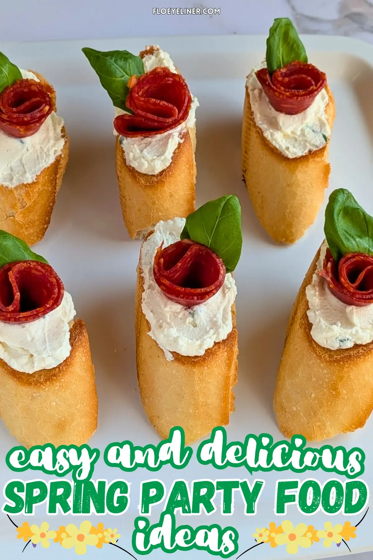 Pepperoni Rose Crostini Appetizers - oven-baked crostini toasts topped with homemade dried onion-fresh thyme cream cheese, slices of pepperoni rolled into roses, and fresh basil leaves for rose leaves.