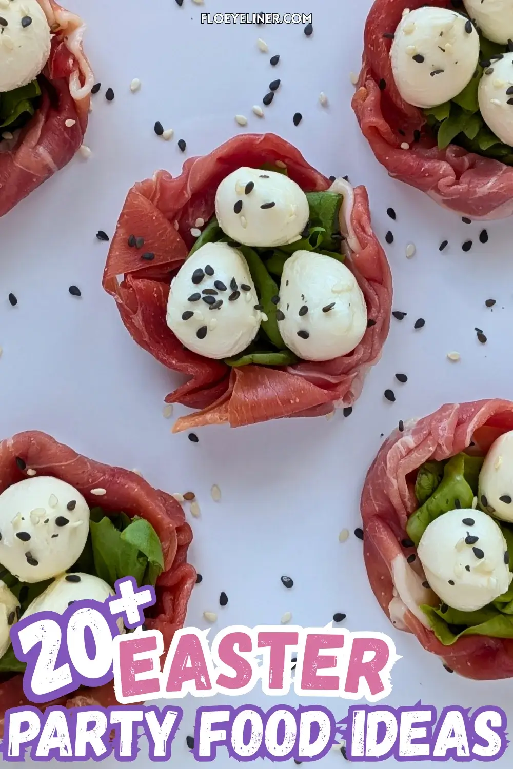 Prosciutto and Mini Mozzarella Bird Nests - easy 4-ingredient prosciutto and mozzarella appetizer with the prosciutto slices forming bird nests and the mini mozzarella balls sitting on green salad leaves as eggs, topped with black and white sesame seeds for speckles.
