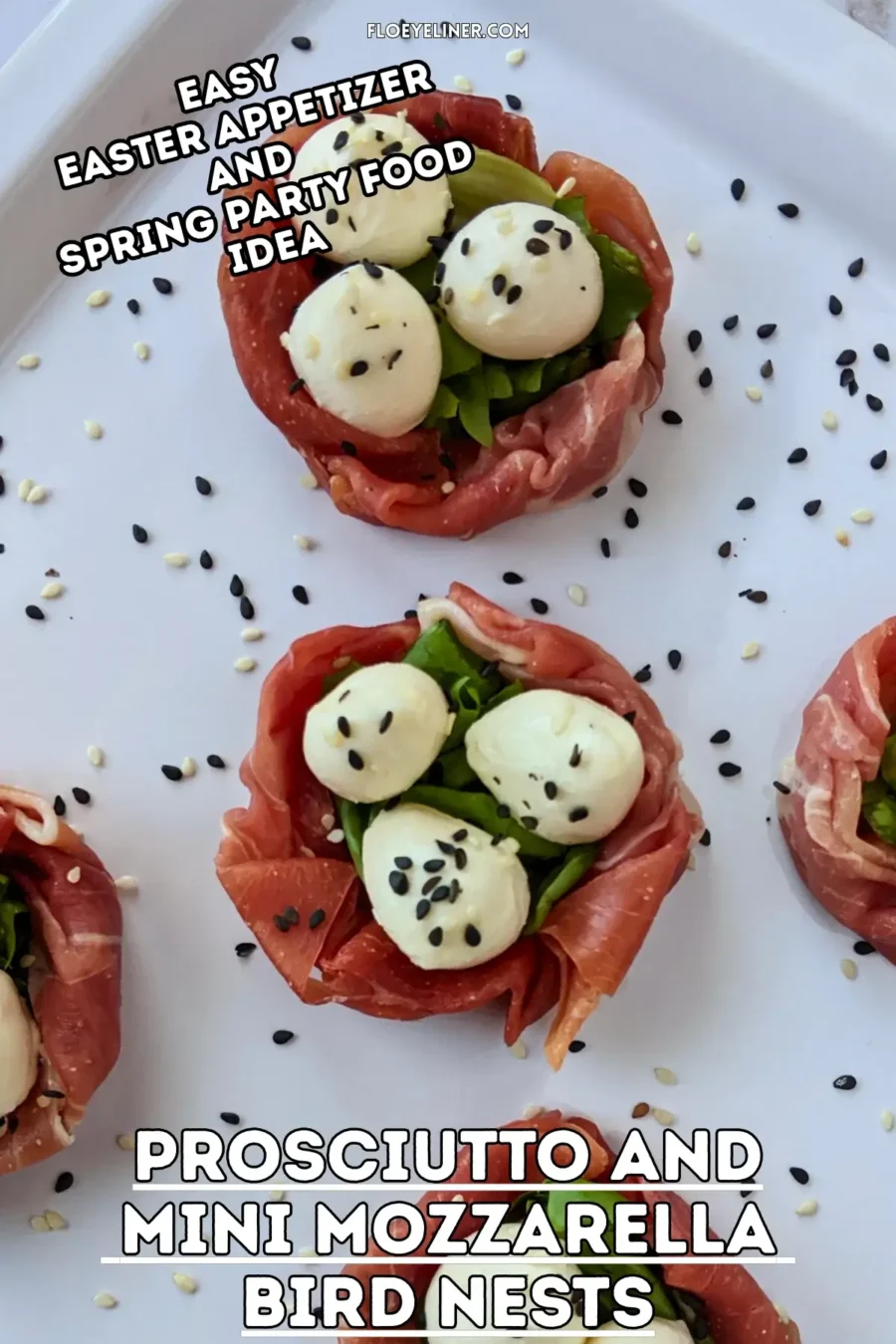 Prosciutto and Mini Mozzarella Bird Nests - easy 4-ingredient prosciutto and mozzarella appetizer with the prosciutto slices forming bird nests and the mini mozzarella balls sitting on green salad leaves as eggs, topped with black and white sesame seeds for speckles.