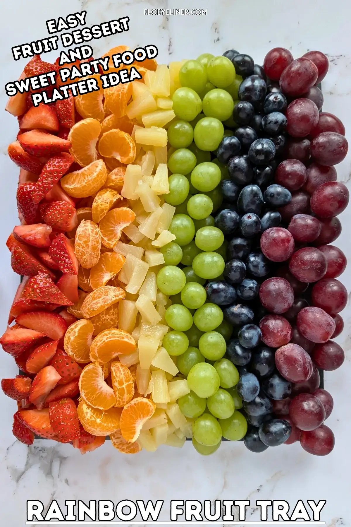 Rainbow Fruit Tray - colorful fruit platter in rainbow colors made with fruits and berries like strawberries, mandarin segments, canned pineapple pieces, green grapes, blue grapes, and dark red grapes.