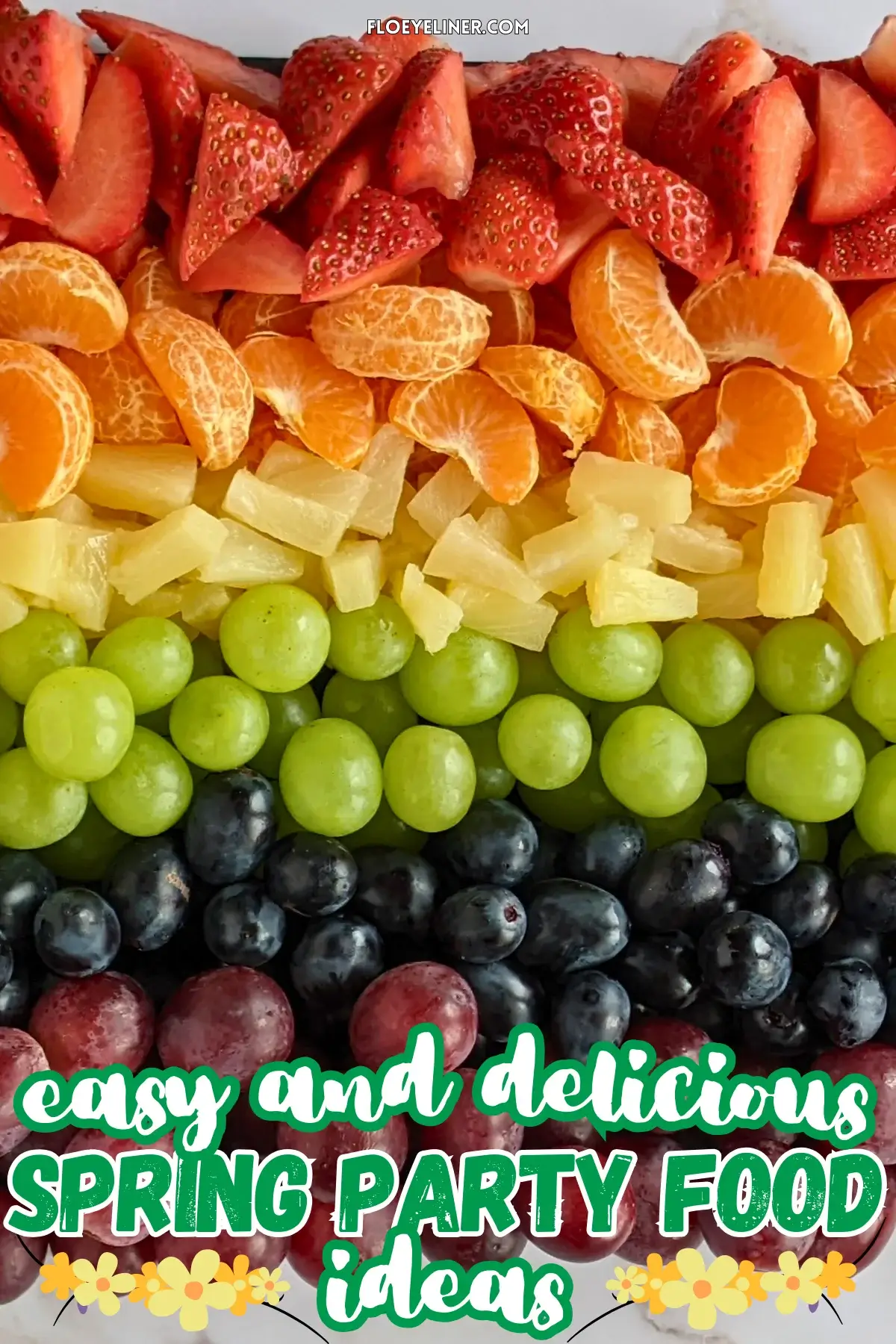 Rainbow Fruit Tray - colorful fruit platter in rainbow colors made with fruits and berries like strawberries, mandarin segments, canned pineapple pieces, green grapes, blue grapes, and dark red grapes.