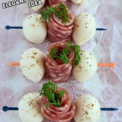 Salami Rose Toothpick Appetizers - easy and elegant party finger food on toothpicks made with slices of salami rolled up into roses and cucumber slices for leaves.