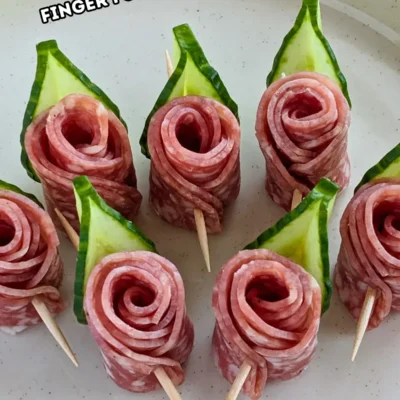 Salami Rose Toothpick Appetizers - easy and elegant party finger food on toothpicks made with slices of salami rolled up into roses and cucumber slices for leaves.