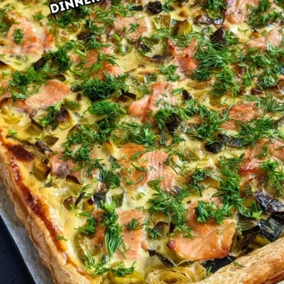 Smoked Salmon and Leek Puff Pastry Tart - puff pastry appetizer or dinner tart topped with buttery cooked leeks and pieces of smoked salmon, drizzled with lemon juice and garnished with fresh dill.