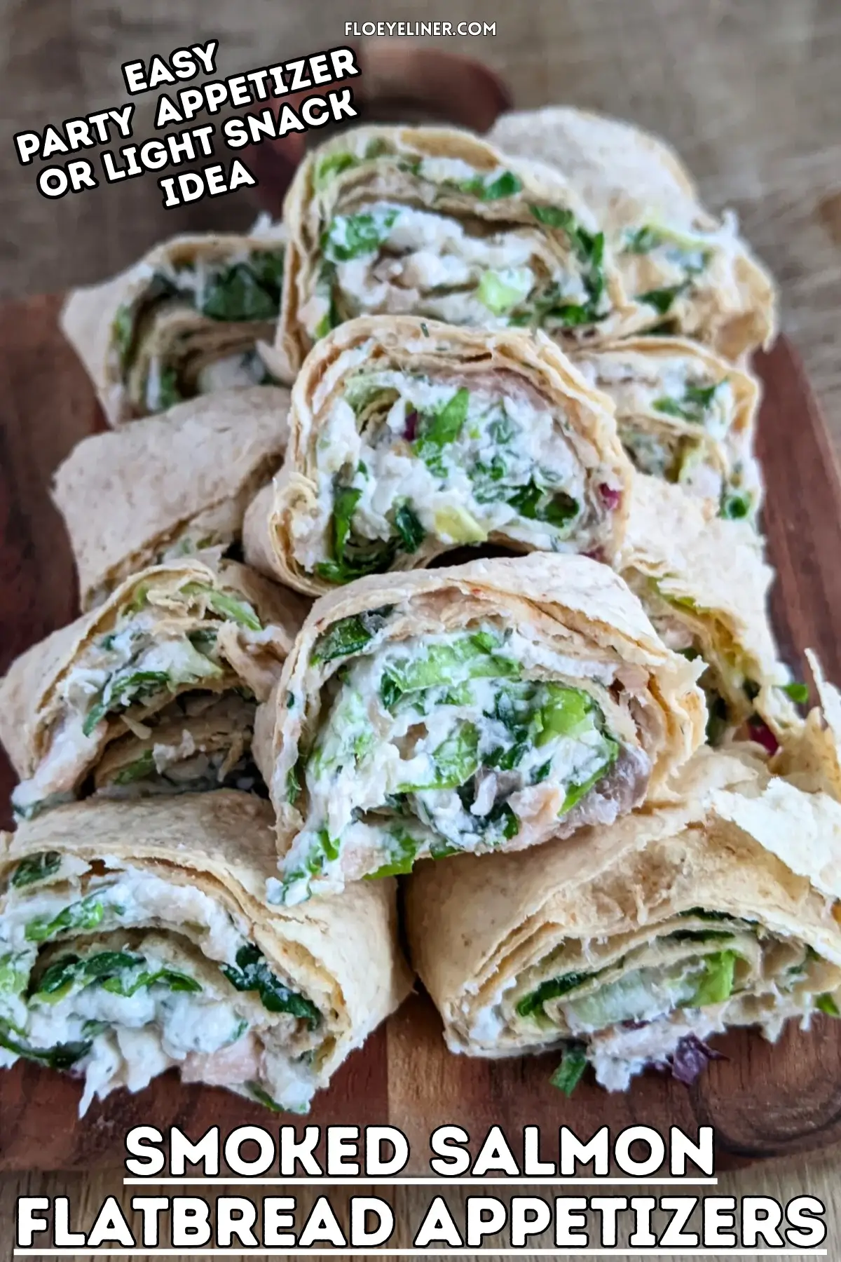 Smoked salmon flatbread appetizers sliced into pinwheels filled with salmon-cream cheese spread and fresh greens.