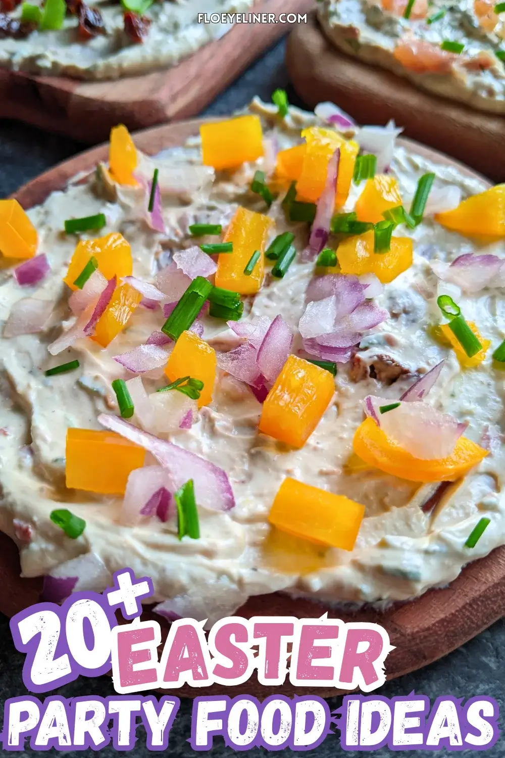 Trio of whipped feta board appetizers, one topped with smoked salmon and fresh chives, the other with sun-dried tomatoes and fresh green onions, and the third with yellow bell peppers, red onion, and fresh chives, all on a creamy feta dip base.