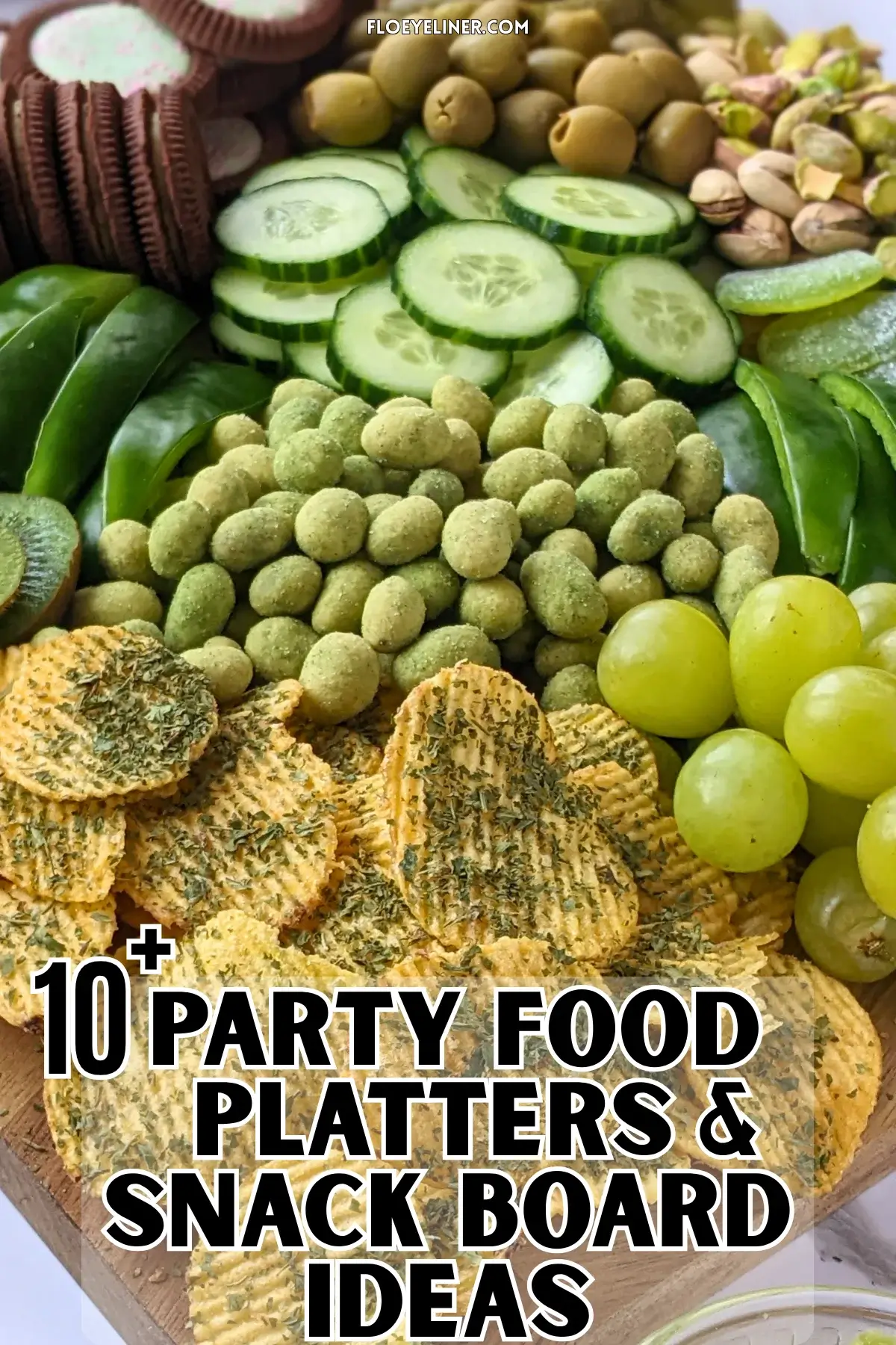 Green Food Board - Green themed party food board and snack tray with homemade tzatziki sauce and simple avocado dip; dried chives covered potato chips; crunchy wasabi coated peanuts; fresh cucumber and green bell peppers; mini pickles; pistachios; olives in brine; fresh fruit like green grapes, green apples, kiwis, and green pears; and a selection of sweet snacks like green gummy candies and Domino's lime and peppermint cookies.