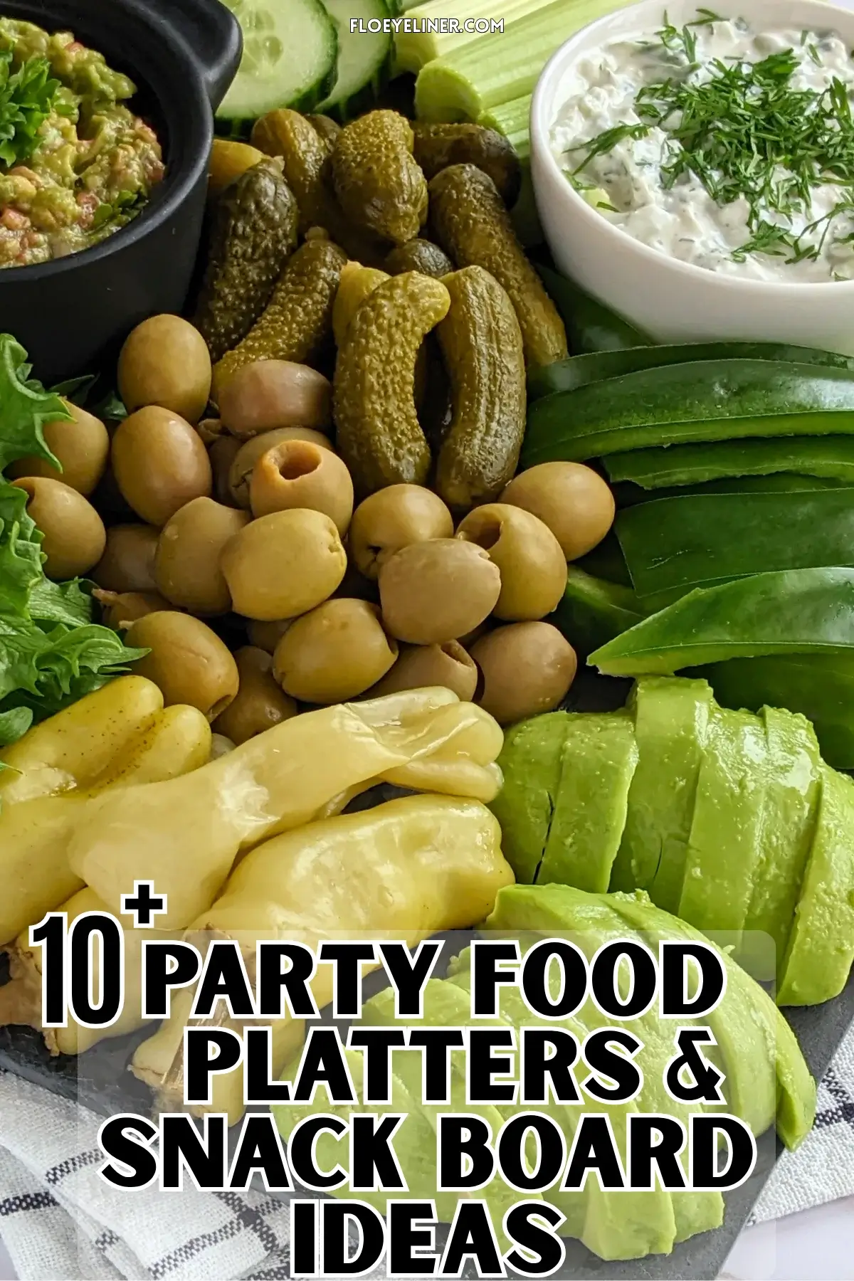 Green Veggie Tray - Green themed vegetable board with homemade guacamole and tzatziki sauce; fresh vegetables like cucumber, green bell peppers, celery, frillice lettuce, and avocado; and pickled foods like mini pickles, jalapenos, and olives in brine.