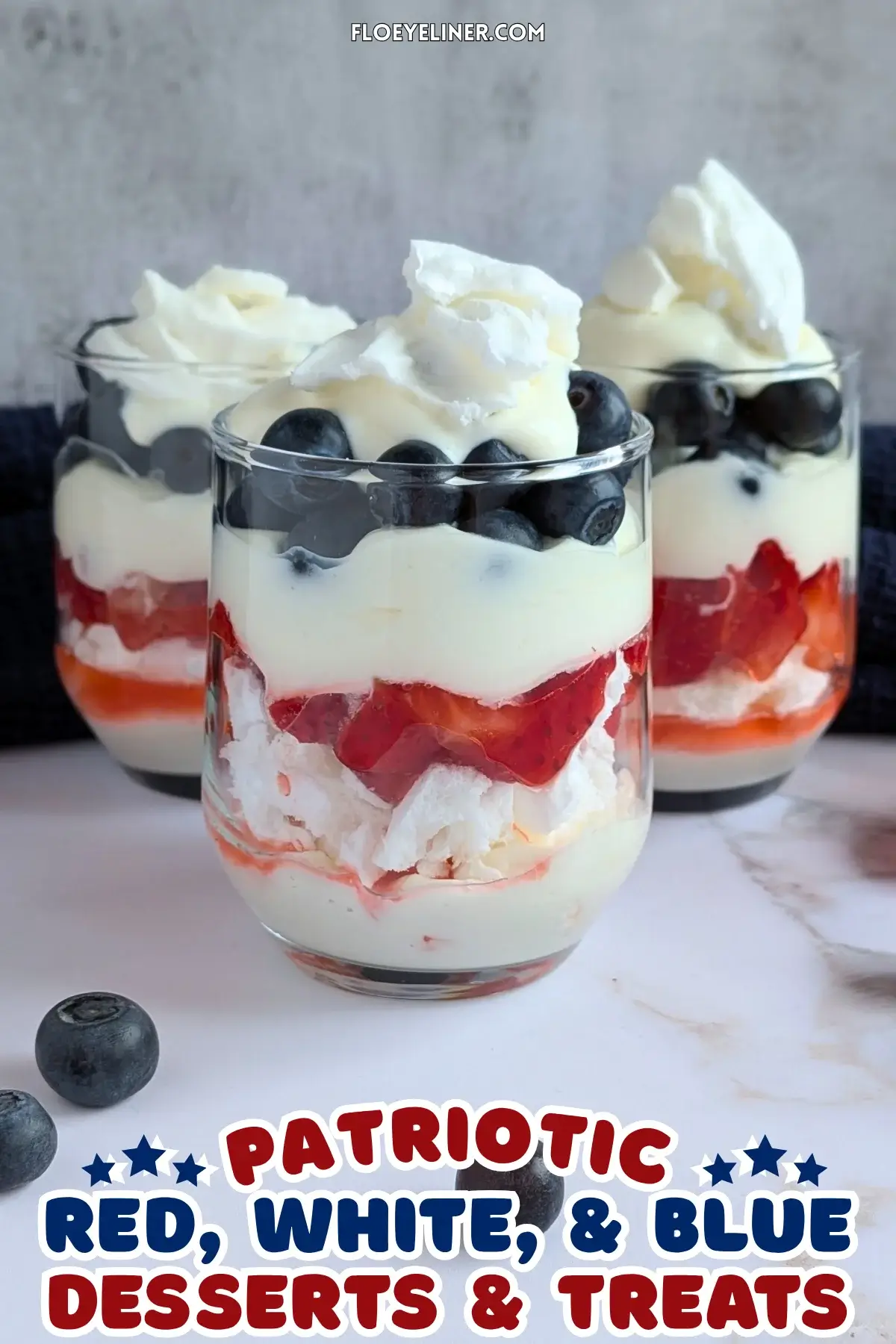 Mixed Berry Eton Mess Desserts - individual eton mess dessert cups, made with layers of mascarpone-whipped cream mix, crushed meringue, fresh strawberries, another layer of mascarpone-whipped cream mix, fresh blueberries, and topped with more cream and crushed meringue.