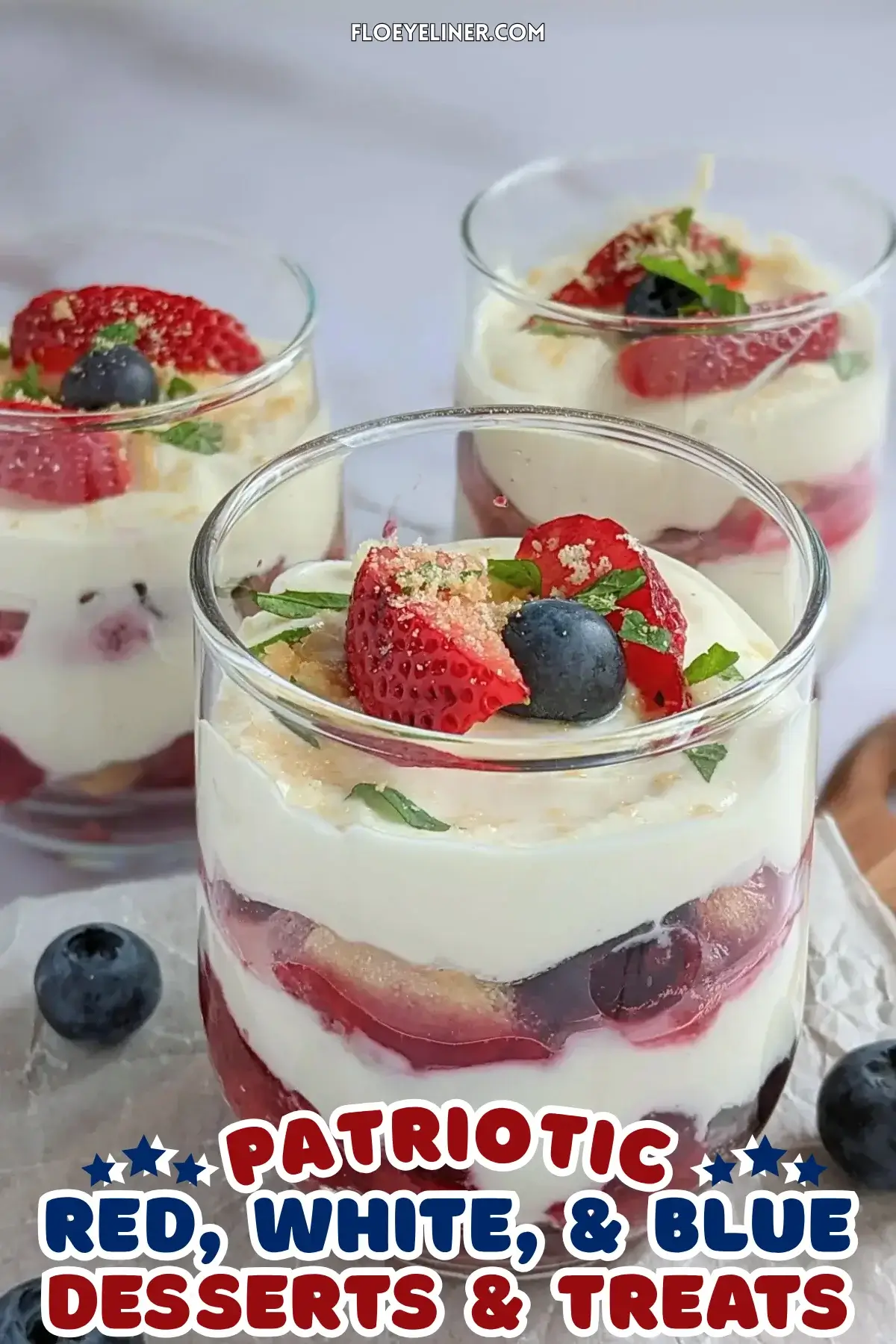 Mixed berry tiramisu in a glass dish with layers of mascarpone, Greek yogurt, and cooked berries like blueberries and strawberries.