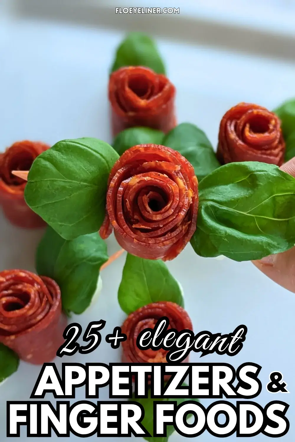 Pepperoni Rose Charcuterie Skewers - party appetizers and finger food on toothpicks made with slices of pepperoni rolled up into roses, fresh basil leaves for rose leaves, and mini mozzarella balls.