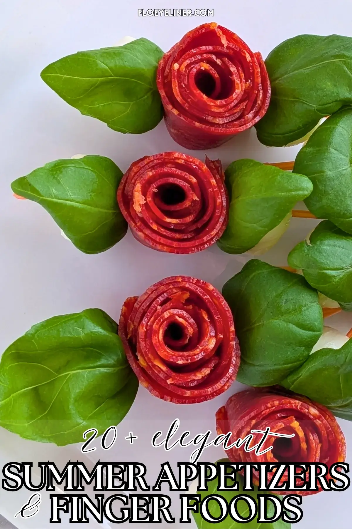 Pepperoni Rose Charcuterie Skewers - party appetizers and finger food on toothpicks made with slices of pepperoni rolled up into roses, fresh basil leaves for rose leaves, and mini mozzarella balls.