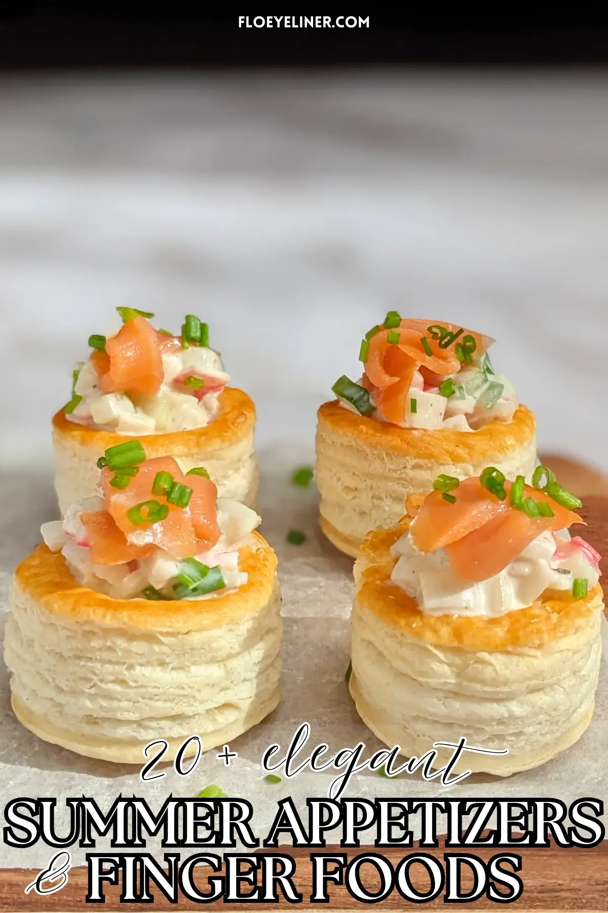 Surimi vol au vent appetizers - puff pastry vol au vent shells filled with a surimi, cucumber, and mayonnaise salad topped with smoked salmon and fresh chives.
