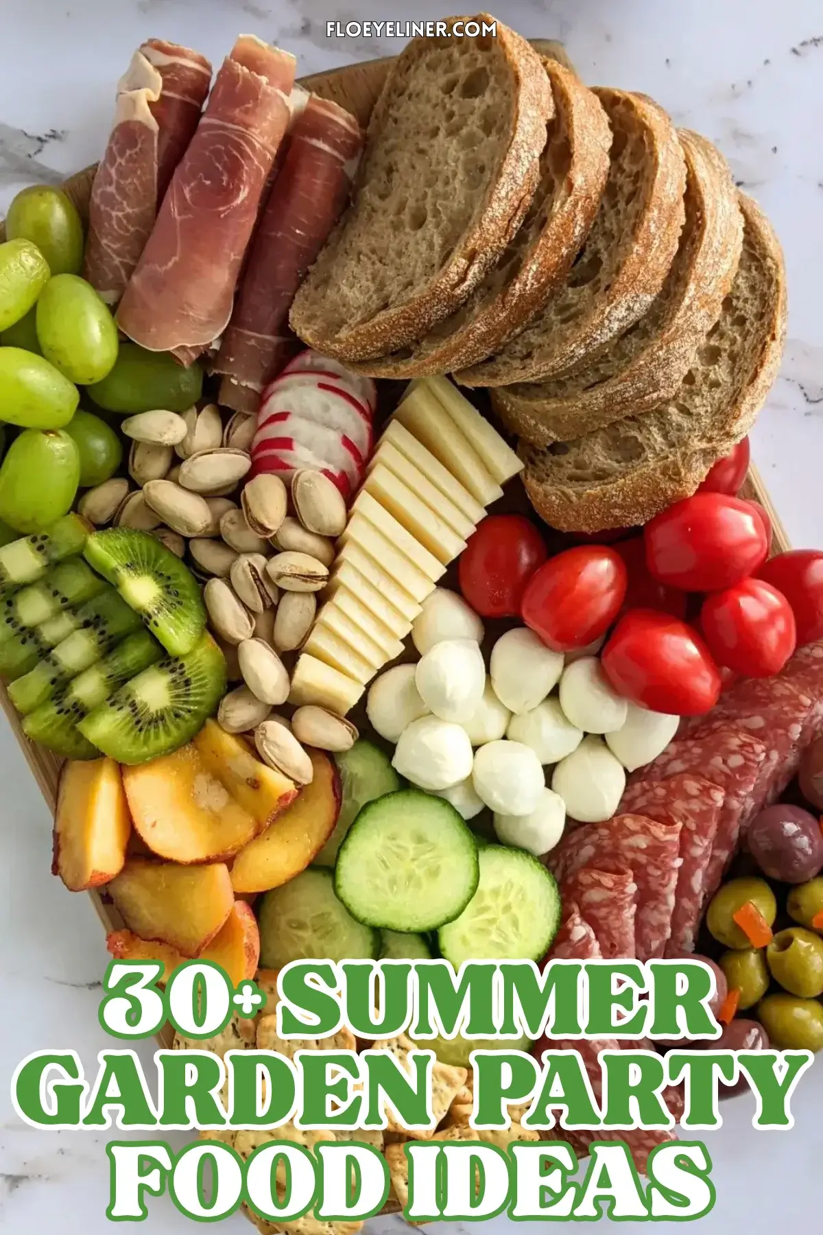 Colorful Antipasto Party Food Platter - A vibrant colorful antipasto party food platter with cured meats, marinated veggies, cheeses, olives, fruit, and ciabatta arranged on a wooden platter.