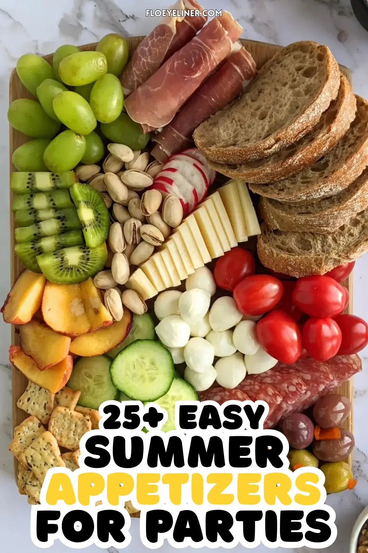 Colorful Antipasto Party Food Platter - A vibrant colorful antipasto party food platter with cured meats, marinated veggies, cheeses, olives, fruit, and ciabatta arranged on a wooden platter.