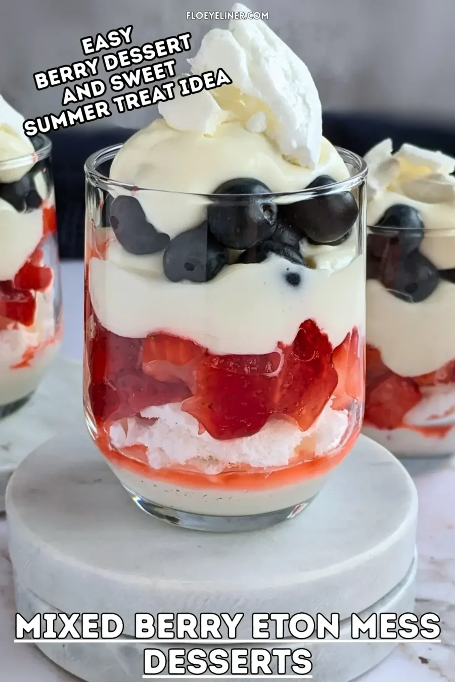 Mixed Berry Eton Mess Desserts - individual eton mess dessert cups, made with layers of mascarpone-whipped cream mix, crushed meringue, fresh strawberries, another layer of mascarpone-whipped cream mix, fresh blueberries, and topped with more cream and crushed meringue.