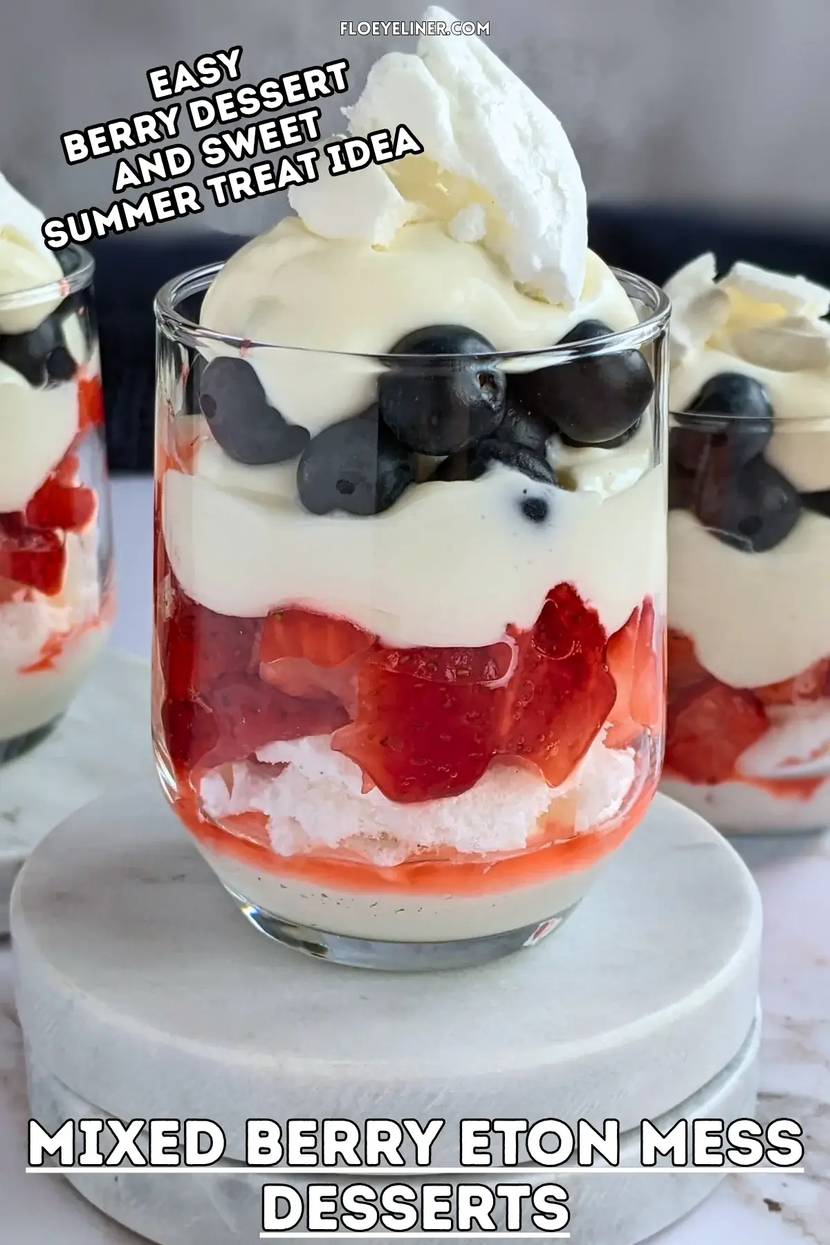 Mixed Berry Eton Mess Desserts - individual eton mess dessert cups, made with layers of mascarpone-whipped cream mix, crushed meringue, fresh strawberries, another layer of mascarpone-whipped cream mix, fresh blueberries, and topped with more cream and crushed meringue.