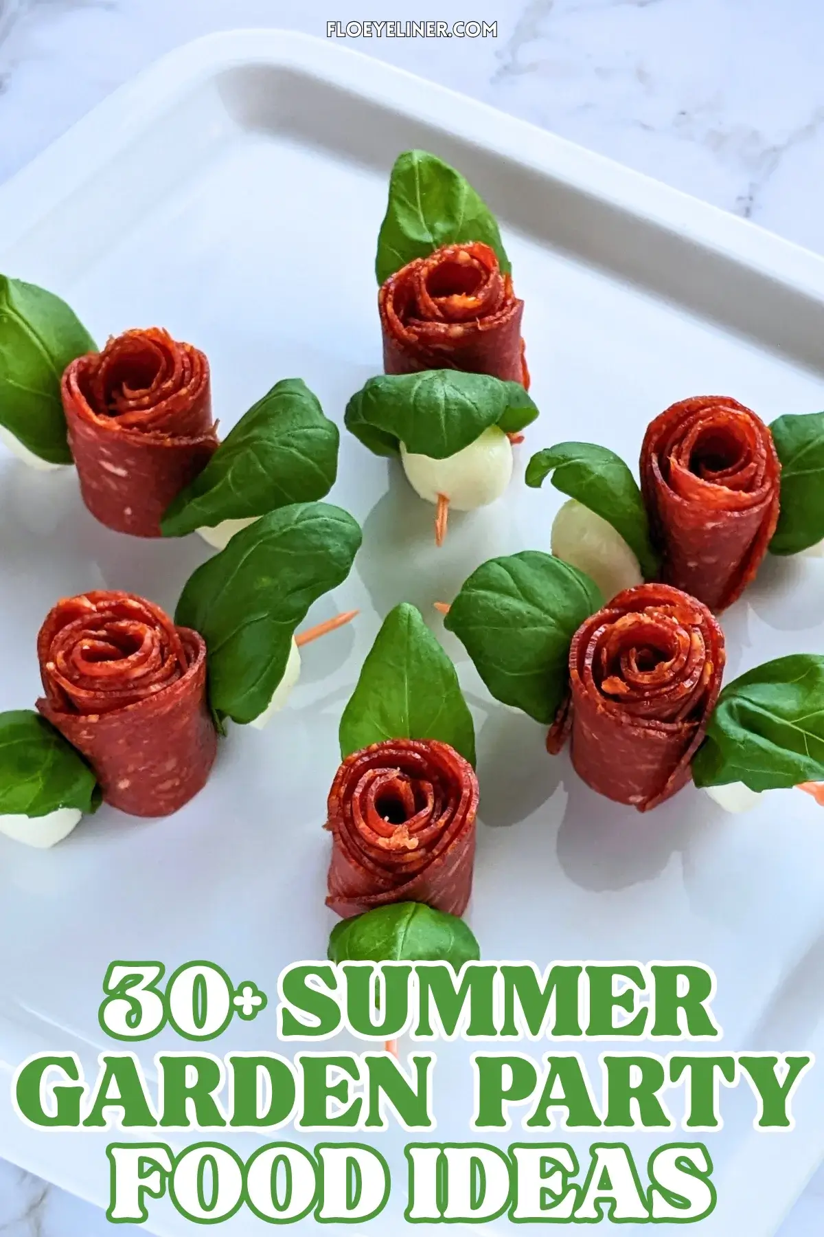 Pepperoni Rose Charcuterie Skewers - party appetizers and finger food on toothpicks made with slices of pepperoni rolled up into roses, fresh basil leaves for rose leaves, and mini mozzarella balls.