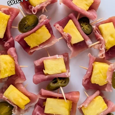 Pineapple and Prosciutto Toothpick Appetizers With Jalapenos - elegant party bites made with prosciutto wrapped fresh pineapple chunks and pickled jalapeno slices on toothpicks.