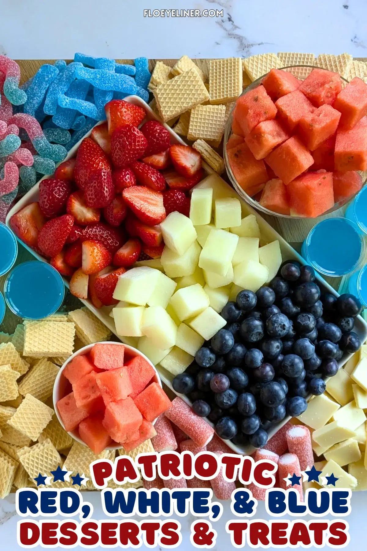 Red, White and Blue Dessert Charcuterie Board - festive red, white, and blue themed dessert tray made with fresh red strawberries and watermelon, plus red sour gummy candies; white honeydew melon, vanilla waffles, and white chocolate; and blue blueberries, blue sour gummy candies, and homemade alcohol-free blue Gatorade jello shots.