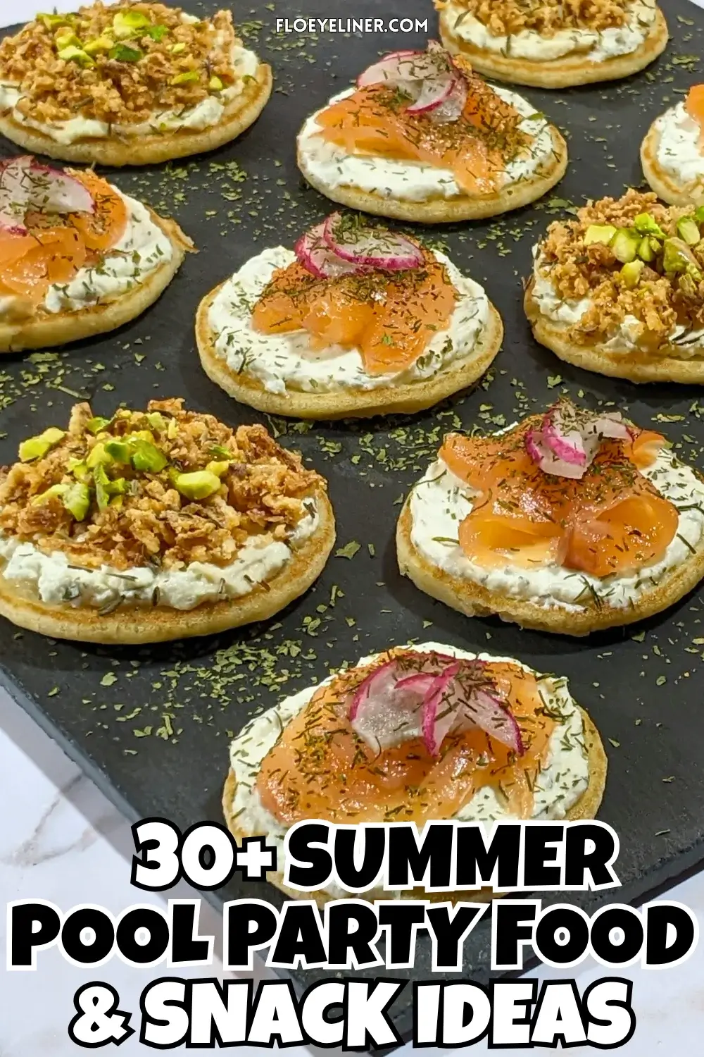 Savory Mini Pancake Appetizer and Snack Board - savory mini pancakes party platter with two types of canapes - mini pancakes topped with a creamy herb-and-garlic cream cheese spread, crispy dried onions, maple syrup, and crushed pistachios and mini pancakes topped with a creamy lemon-dill cream cheese spread, pieces of smoked salmon, and radish slices.