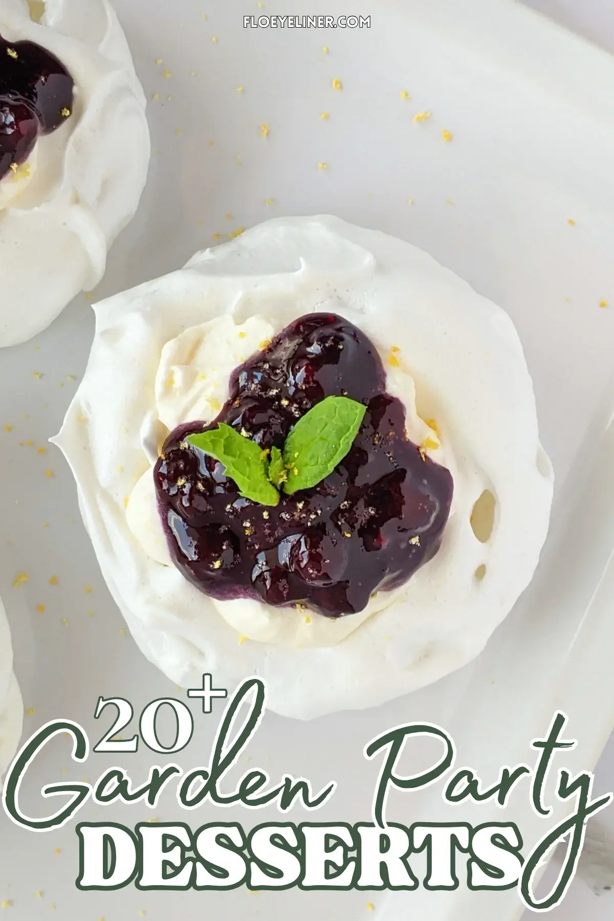 Lemon Blueberry Mini Pavlovas With Cheesecake Filling - mini pavlova nests filled with homemade lemon blueberry jam and a lemony cheesecake filling, topped with more blueberry jam and lemon zest for garnish.