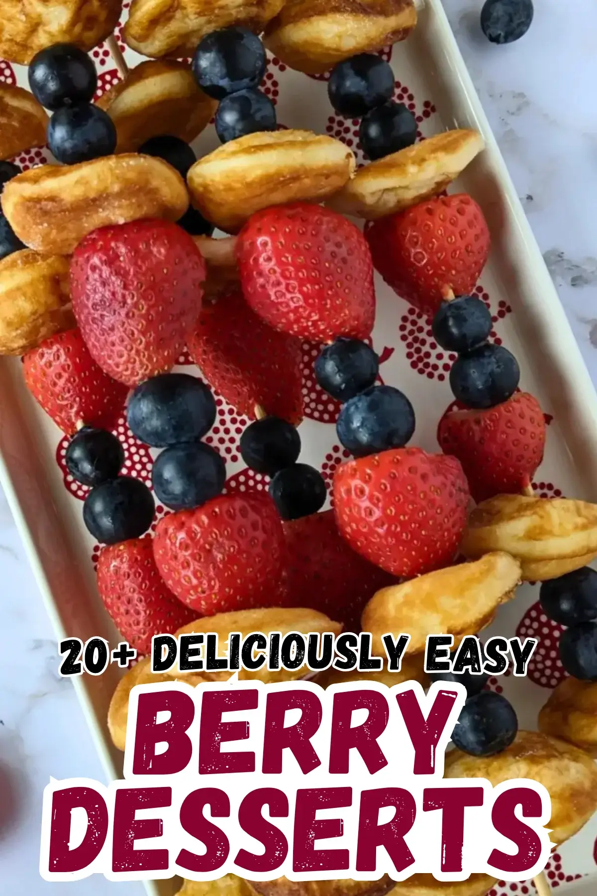 Mini Pancake Skewers With Fresh Berries - dessert skewers on toothpicks made with alternating layers of mini pancakes and fresh strawberries and blueberries.