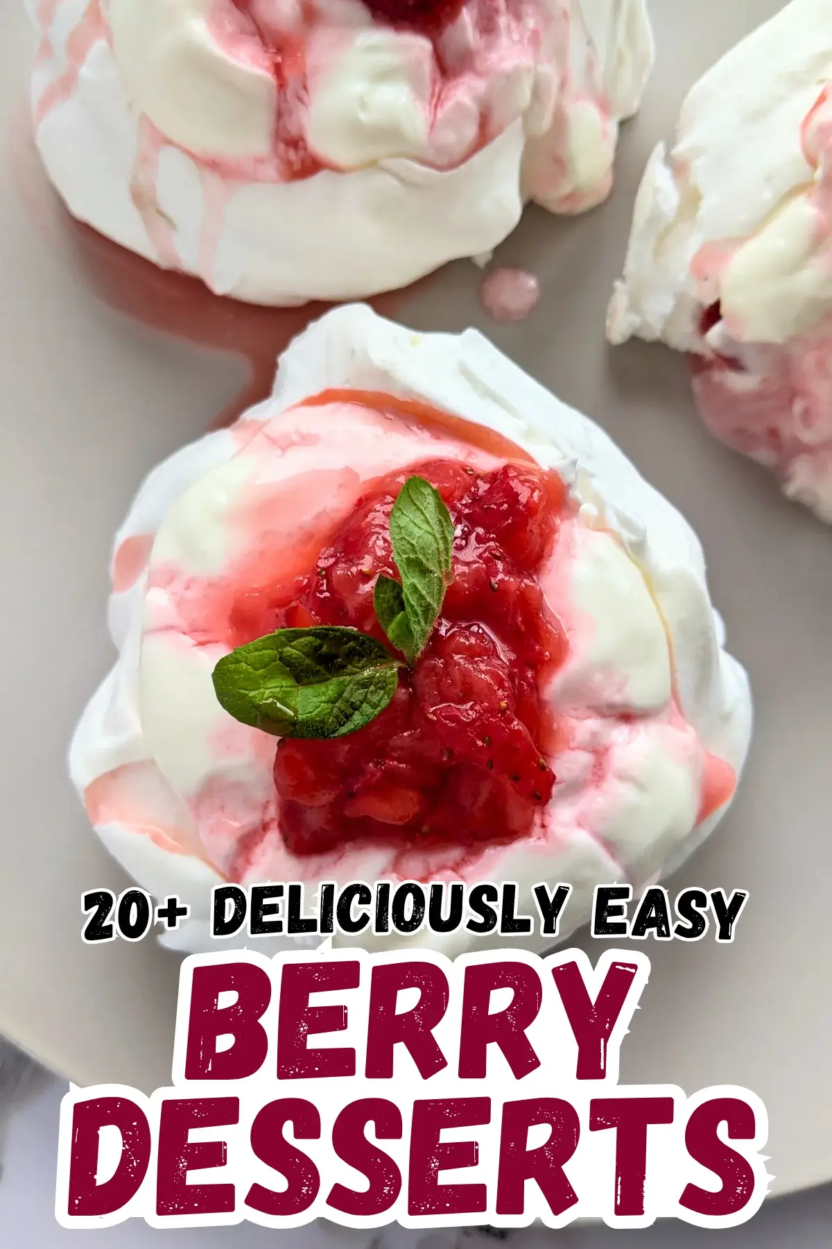 Mini Strawberry Pavlovas With Whipped Greek Yogurt - mini pavlova nests filled with freshly crushed strawberries and a whipped cream-Greek yogurt mix, topped with more crushed strawberries and strawberry juice for garnish.