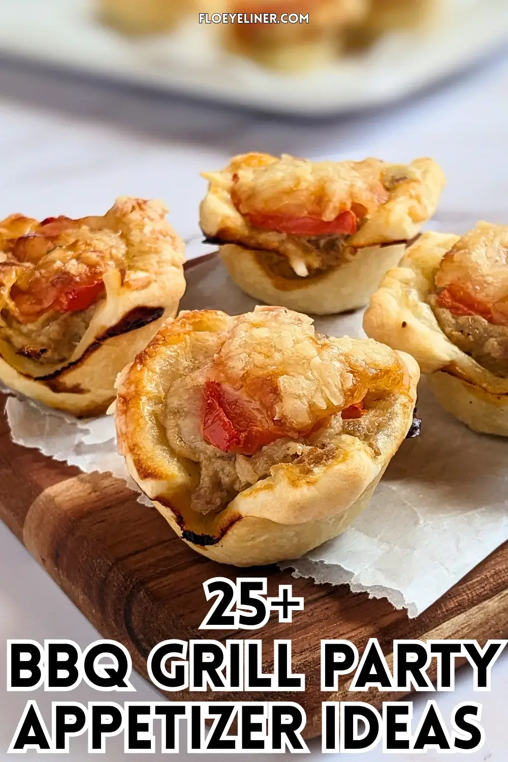 Mini Tuna Tart Cups With Puff Pastry - mini tuna tart appetizers made in a mini muffin tin with a canned tuna and sour cream filling and grated cheese topping in puff pastry cups.