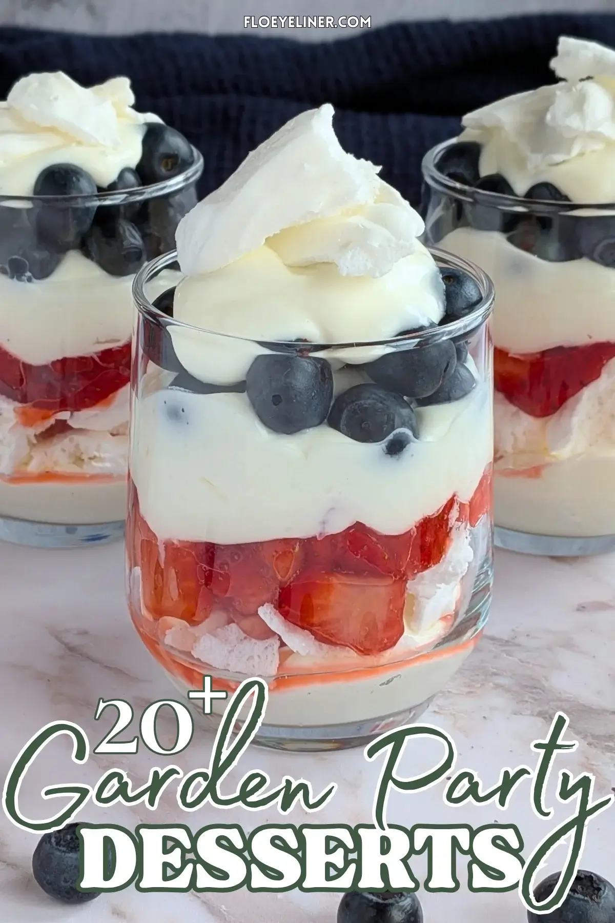 Mixed Berry Eton Mess Desserts - individual eton mess dessert cups, made with layers of mascarpone-whipped cream mix, crushed meringue, fresh strawberries, another layer of mascarpone-whipped cream mix, fresh blueberries, and topped with more cream and crushed meringue.