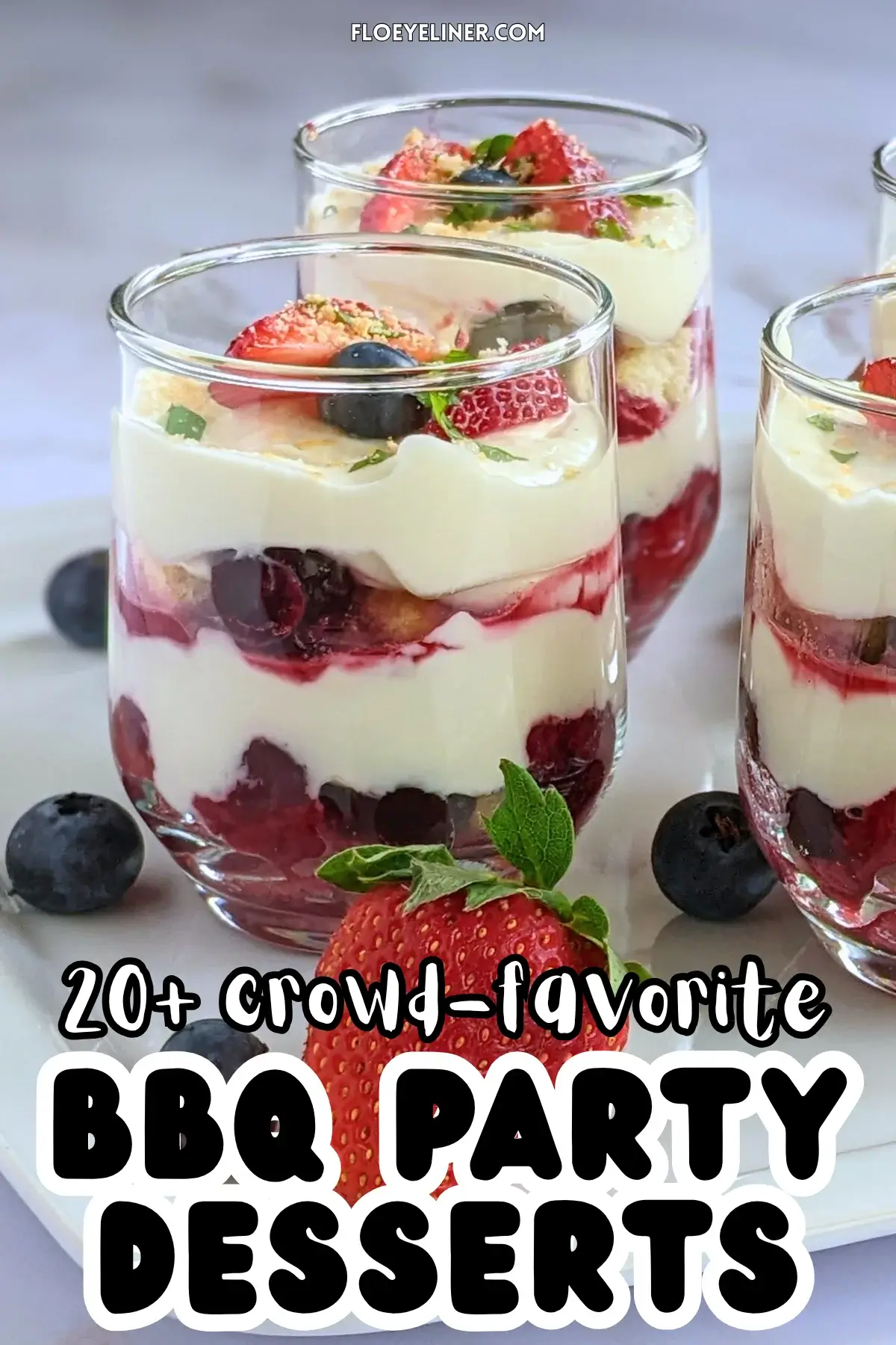 Mixed berry tiramisu in a glass dish with layers of mascarpone, Greek yogurt, and cooked berries like blueberries and strawberries.