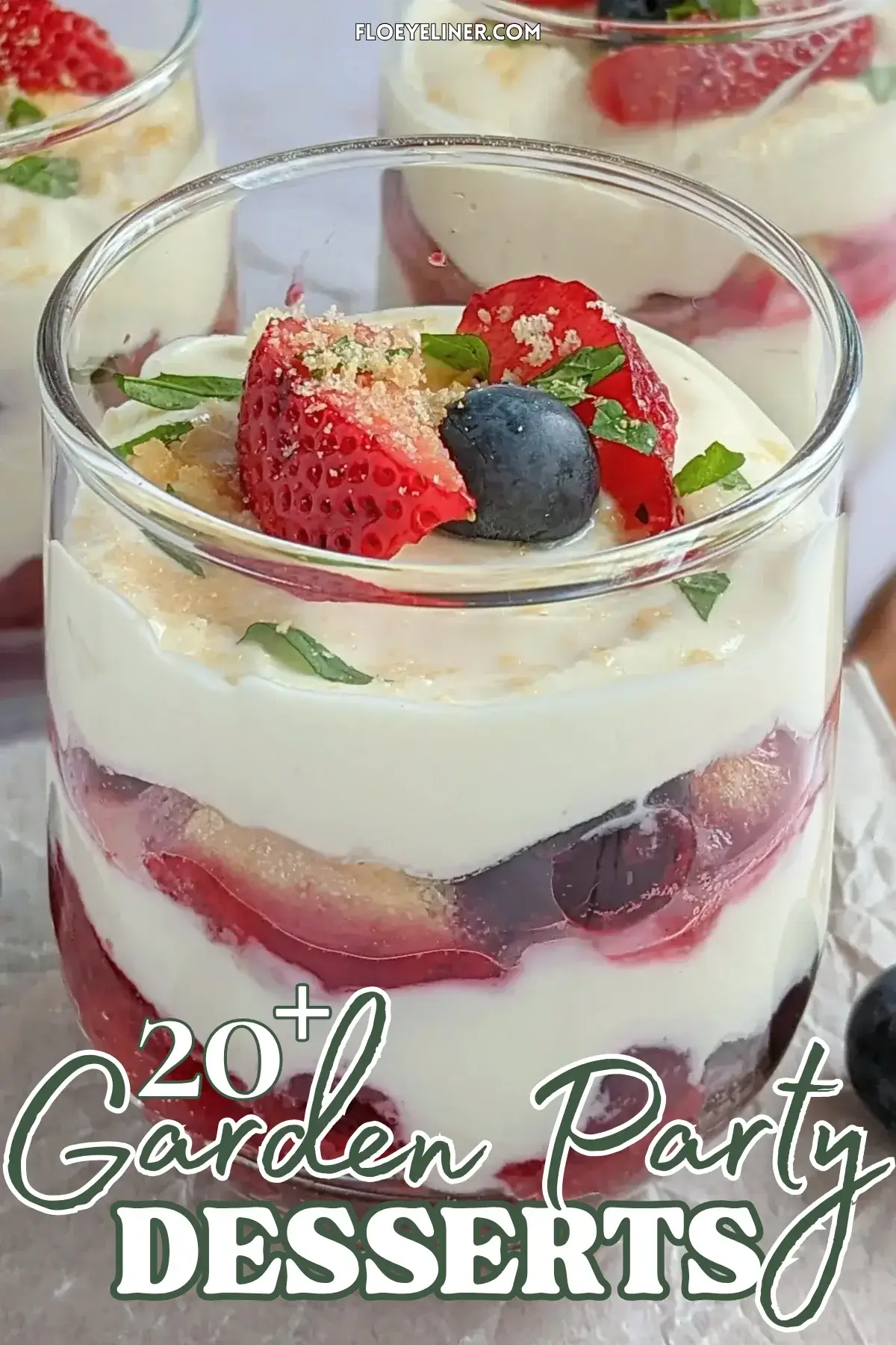 Mixed berry tiramisu in a glass dish with layers of mascarpone, Greek yogurt, and cooked berries like blueberries and strawberries.
