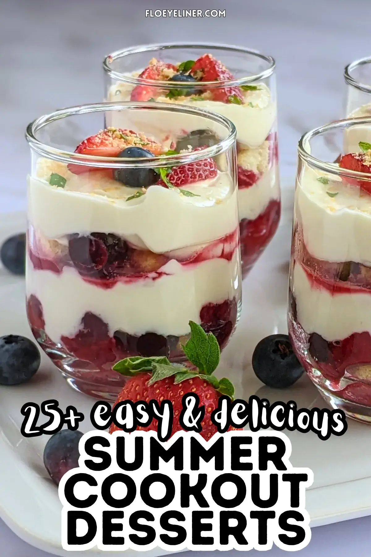 Mixed berry tiramisu in a glass dish with layers of mascarpone, Greek yogurt, and cooked berries like blueberries and strawberries.