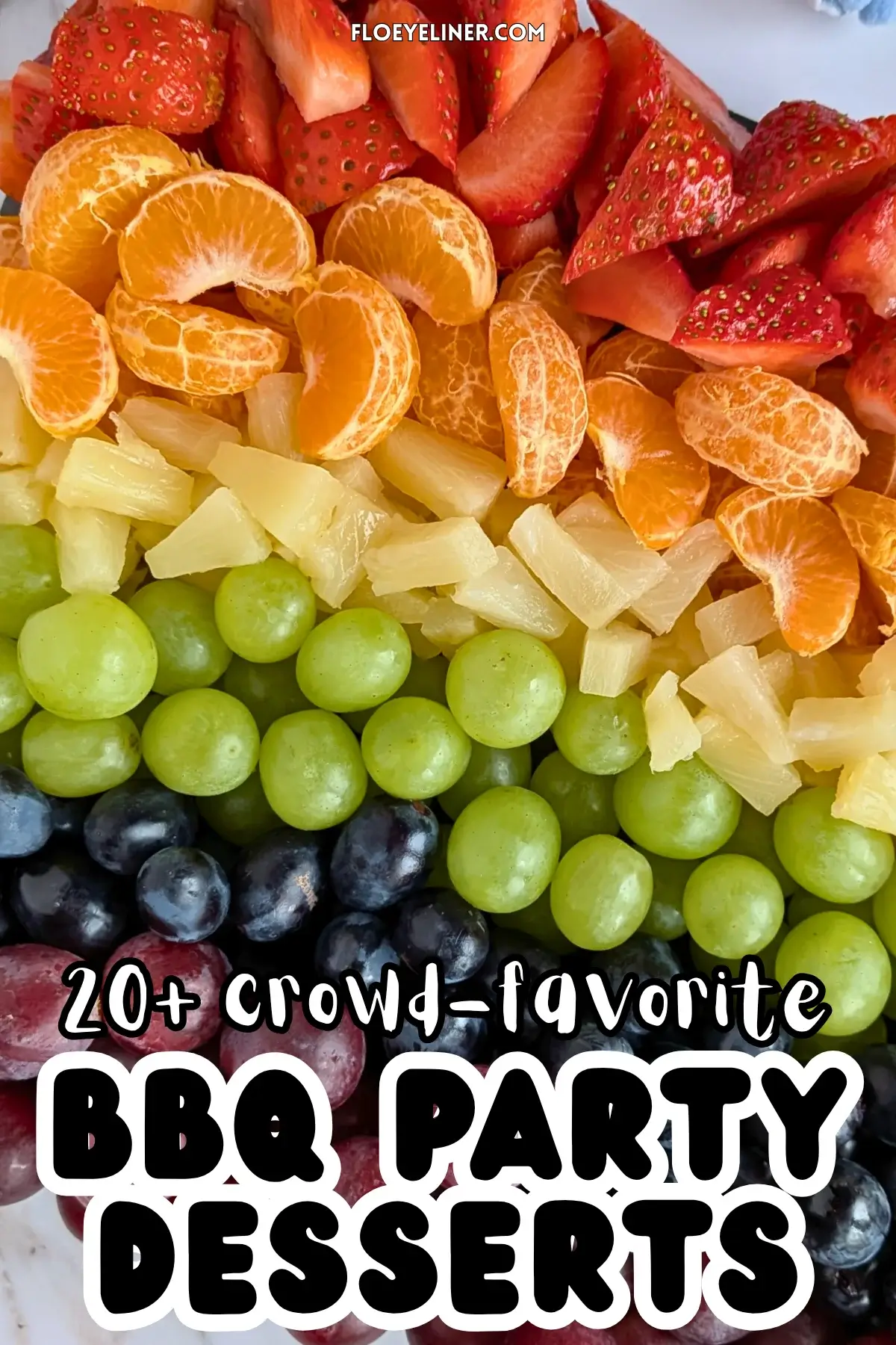 Rainbow Fruit Tray - colorful fruit platter in rainbow colors made with fruits and berries like strawberries, mandarin segments, canned pineapple pieces, green grapes, blue grapes, and dark red grapes.
