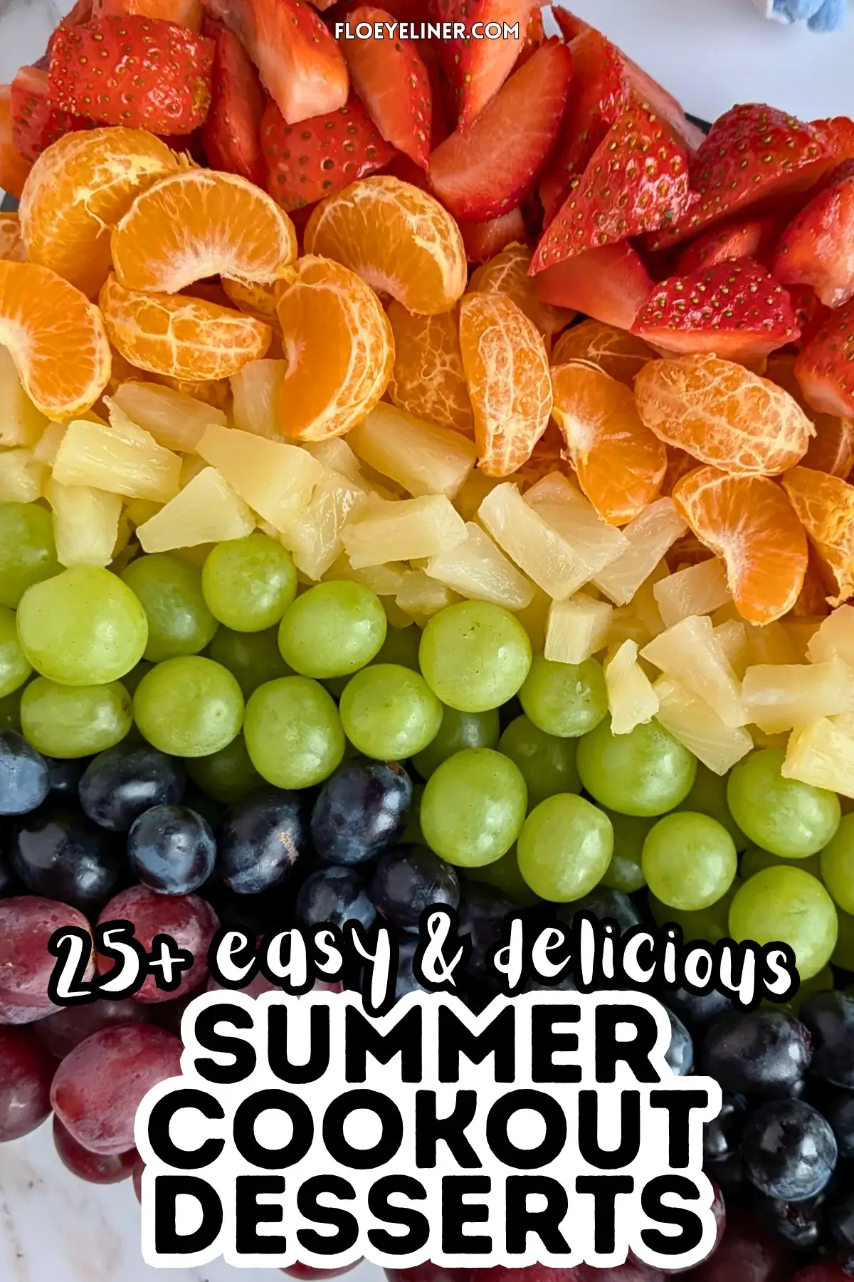 Rainbow Fruit Tray - colorful fruit platter in rainbow colors made with fruits and berries like strawberries, mandarin segments, canned pineapple pieces, green grapes, blue grapes, and dark red grapes.