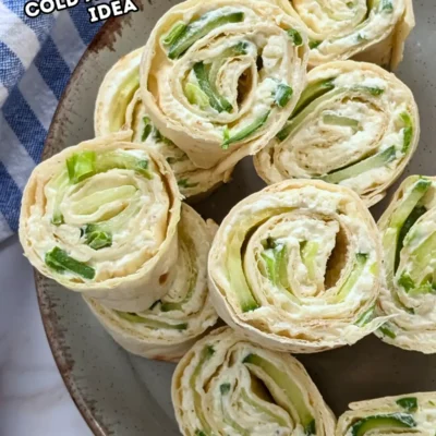 Cheesy Cucumber Tortilla Pinwheels - tortilla roll ups filled with a cream cheese, grated cheese, and chopped fresh green onions mix, layered with slices of cucumber.