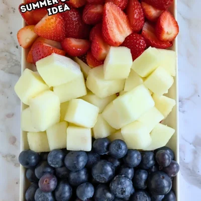 Red, White and Blue Fruit Tray - easy festive party fruit platter made with cut red strawberries, white honeydew melon, and blue blueberries for a red, white, and blue themed summer dessert or snack board.